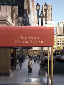 a sign for the inn at union square on a city street at Inn at Union Square in San Francisco