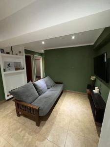 uma sala de estar com um sofá e uma televisão de ecrã plano em Lindo departamento pleno centro. em San Fernando del Valle de Catamarca