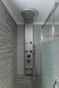 a bathroom with a shower with a shower head at Villa Nektar, Luxury Apartment in Chora Naxos in Naxos Chora
