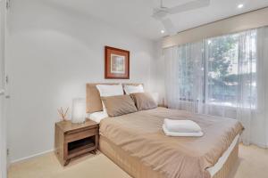 a bedroom with a large bed with a window at Ren Basera in Mount Buller