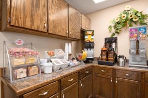 a kitchen with a counter with food on it at Super 8 by Wyndham Hattiesburg North in Hattiesburg