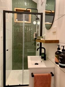 a bathroom with a shower and a white sink at Stylish Geelong Cabin - Your home away from home in Belmont