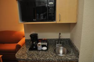 a kitchen counter with a sink and a microwave at Hampton Inn & Suites Cathedral City in Cathedral City