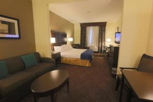 a hotel room with a bed and a couch at Hampton Inn & Suites Cathedral City in Cathedral City