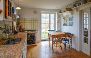 a kitchen with a table and chairs and a sink at Beautiful Home In Anholt With 4 Bedrooms in Anholt