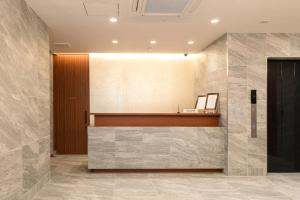 a lobby with a reception desk in a building at Cinnamonhotel2 in Osaka