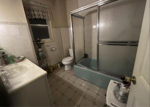 a bathroom with a shower and a toilet and a sink at JC Denman in Corona