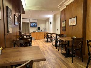 a dining room with wooden tables and chairs at Hotel Kaya Est 1985 in Istanbul