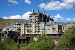 a large building with a mountain in the background at The Westin Riverfront Mountain Villas, Beaver Creek Mountain in Avon