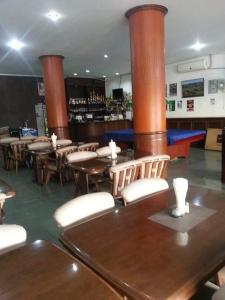 een restaurant met houten tafels en stoelen en een bar bij the links hotel in Pattaya