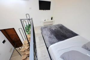 a bedroom with a bed and a tv on a wall at Katia Charme in Rome