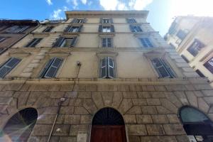 a tall building with a door in front of it at Katia Charme in Rome