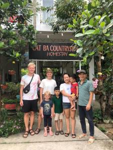 a group of people standing in front of a building at Cat Ba Countryside Homestay in Cat Ba