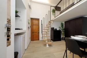 a living room with a staircase and a dining table at Katia Charme in Rome