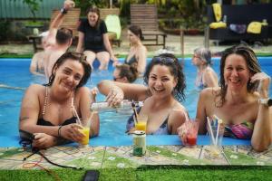 a group of women sitting in a pool with drinks at Cat Ba Countryside Homestay in Cat Ba