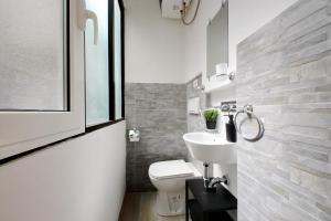 a bathroom with a white toilet and a sink at Katia Charme in Rome +12 photos
