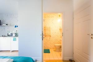 a room with a bathroom with a toilet and a sink at Pilotow 87 Apartments in Krakow