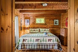 1 dormitorio con 1 cama en una cabaña de madera en Cozy cabin with a mountain view en Pigeon Forge