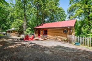 a cabin in the woods with a red roof at Cozy cabin with a mountain view in Pigeon Forge