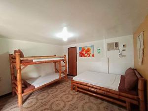 a room with two bunk beds in it at Casa Astillero - Calatagan Batangas Private Resort in Calatagan