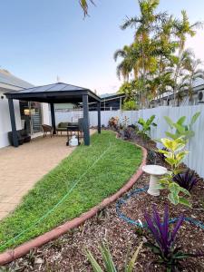 a backyard with a gazebo and some grass at The OC Home: Centrally Located, Home Away Home in Nightcliff