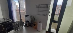 a kitchen counter with utensils on a window sill at Wohnung Queens Deluxe in Bogotá