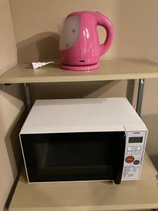 a pink tea pot sitting on top of a microwave at Babaji's Kriya Yoga Restoration Center - Vacation STAY 27036v in Hokuto