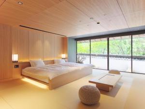 a bedroom with a large bed and a large window at Nanzenji sando KIKUSUI in Kyoto