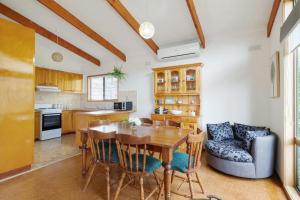 a kitchen and dining room with a wooden table and chairs at Plover Haven in Cowes