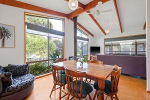 a dining room with a wooden table and chairs at Plover Haven in Cowes +8 photos