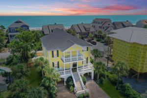 an aerial view of a yellow house with a balcony at Beach Haven in North Litchfield Beach