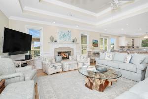 a living room with a table and a fireplace at Beach Haven in North Litchfield Beach