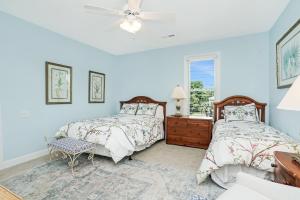 a bedroom with two beds and a window at Beach Haven in North Litchfield Beach