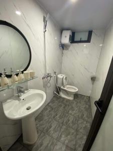 a bathroom with a sink and a toilet at CuDen Homestay Venuestay in Vĩnh Phúc