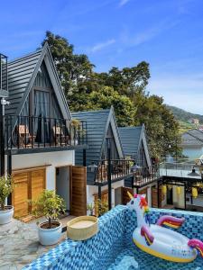 a house with a swimming pool with a toy unicorn at CuDen Homestay Venuestay in Vĩnh Phúc +12 photos