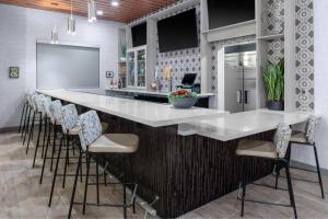 una cocina con un gran mostrador blanco con taburetes de bar en Fairfield by Marriott Inn & Suites Buckeye Verrado, en Buckeye