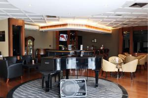 a lobby with a piano and a bar at Hotel Dafam Semarang in Semarang