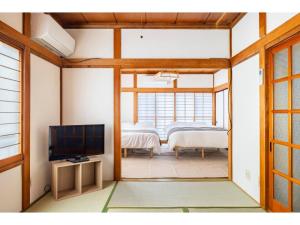 Habitación con sala de estar con TV y habitación con habitación. en Nikko Main Street House - Vacation STAY 04324v en Nikko