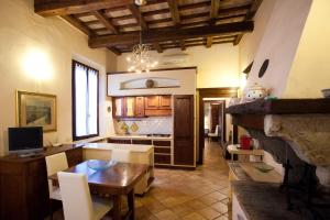 a kitchen with a table and a dining room at Relais B&B Corte Dei Turchi in Longiano