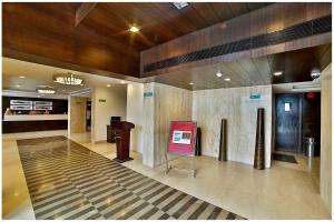 a lobby with a sign in the middle of a building at SVN GRAND in Kākināda
