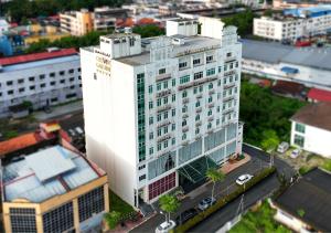an aerial view of a white building in a city at Crown Garden Hotel in Kota Bharu