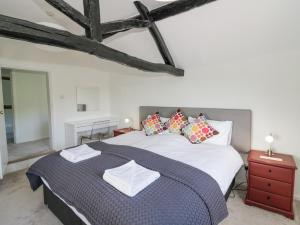 a bedroom with a large bed with pillows on it at Crews Hill House in Worcester