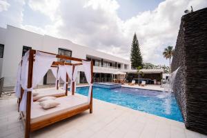 a house with a swimming pool and a bed in front of a house at luxury suite presidencial 