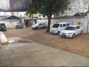 a group of three cars parked next to a building at Hotel Colonial Plaza in Bucaramanga