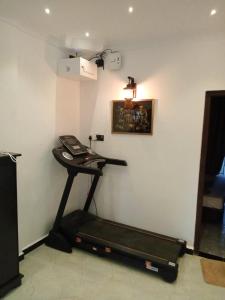 a room with a treadmill and a phone on a wall at CEYLON VILLA NILAVELI in Trincomalee