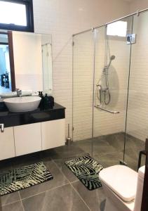 a bathroom with a sink and a glass shower at Kluai Mai Luxury Pool Villa, Panorama Resort in Hua Hin