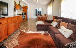 a living room with a couch and a kitchen at Amazing Home In Deltebre With Kitchen in Deltebre