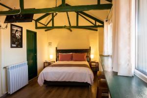 a bedroom with a bed and a green door at Hostal Corihuasi in Cusco