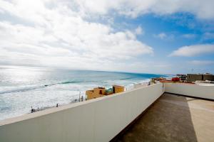 a view of the ocean from the balcony of a building at Ocean-VIEW Two Story Condo on the beach in Tijuana