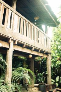 a wooden deck in a garden with plants at laolulodge in Luang Prabang